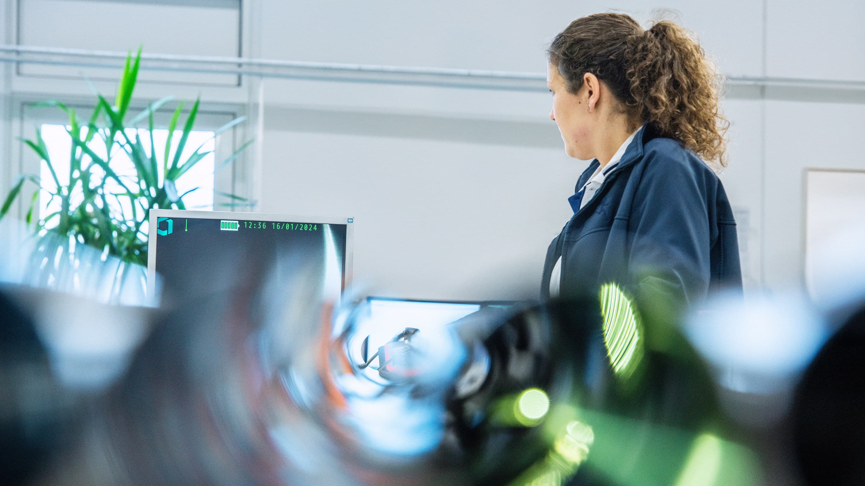 A woman carefully examines a tube