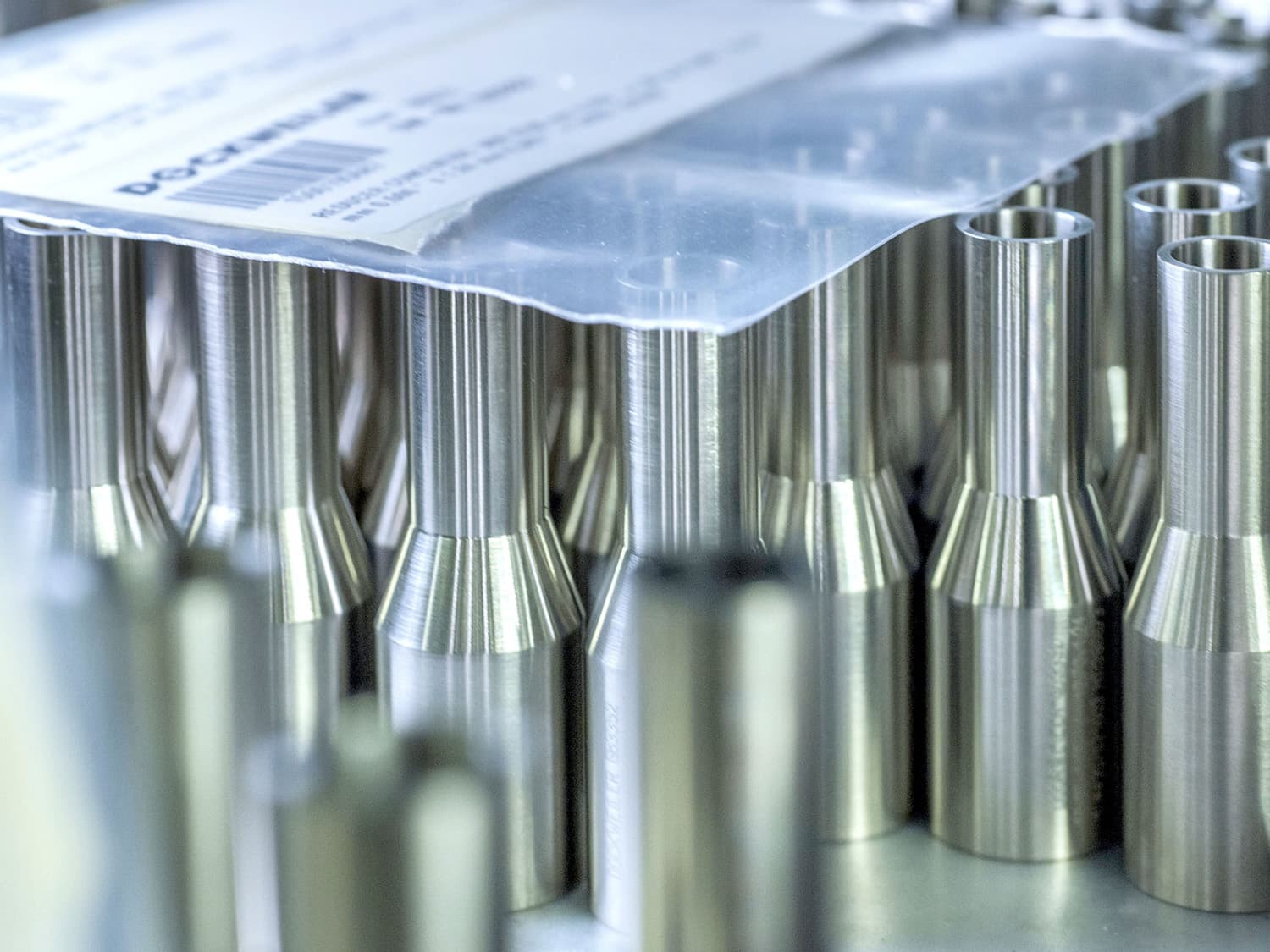 Concentric stainless steel reducers standing next to each other in the storage shelf