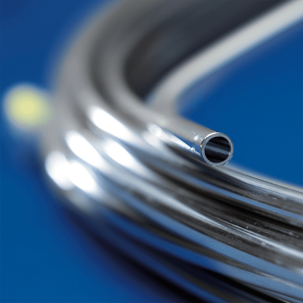 Electropolished coiled tubing on a blue background