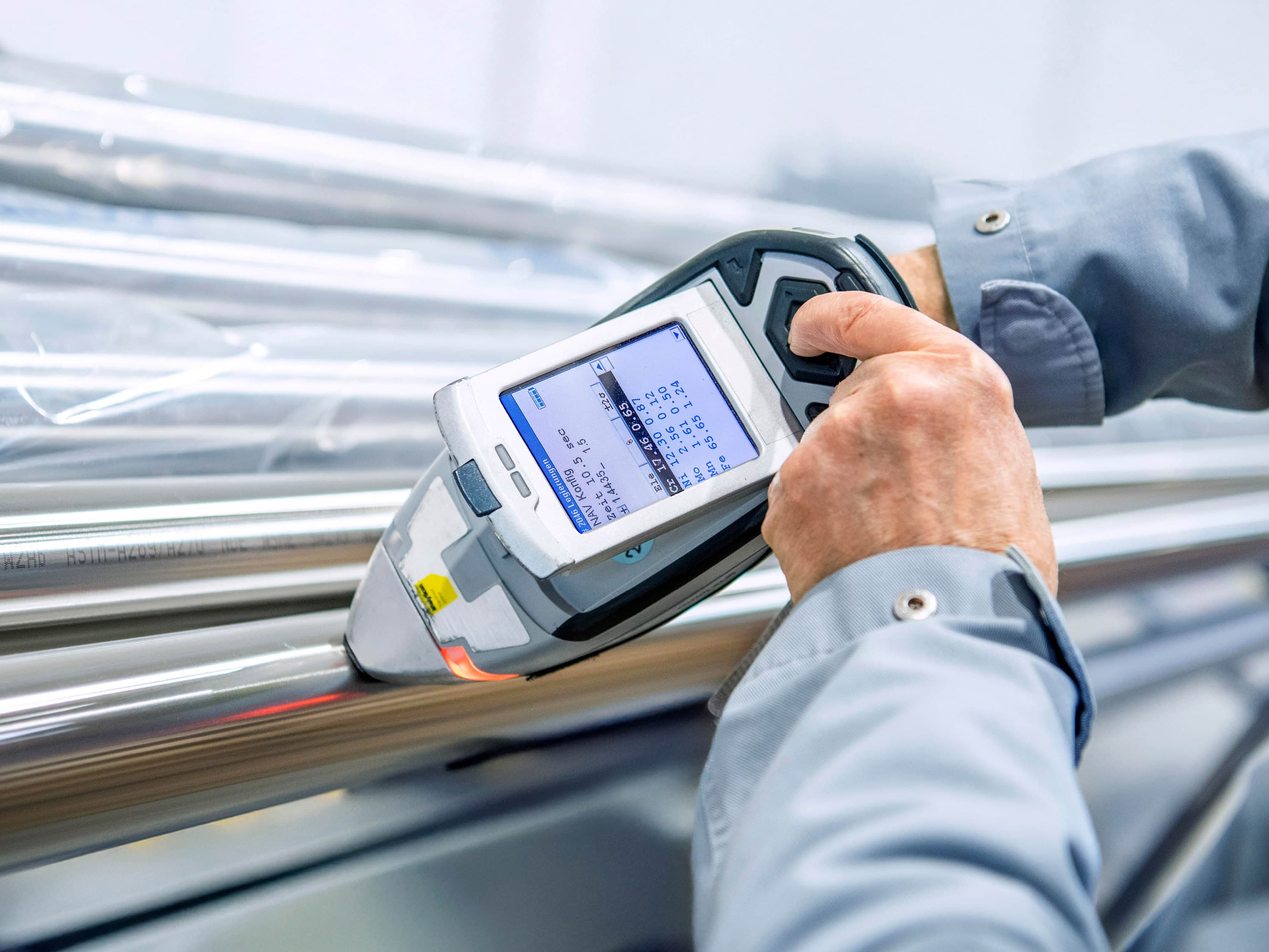 Person is using a device to carry out a material identification check