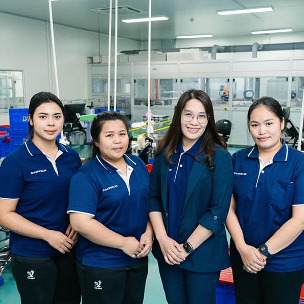 Women in work clothes work in quality assurance at Dockweiler Asia
