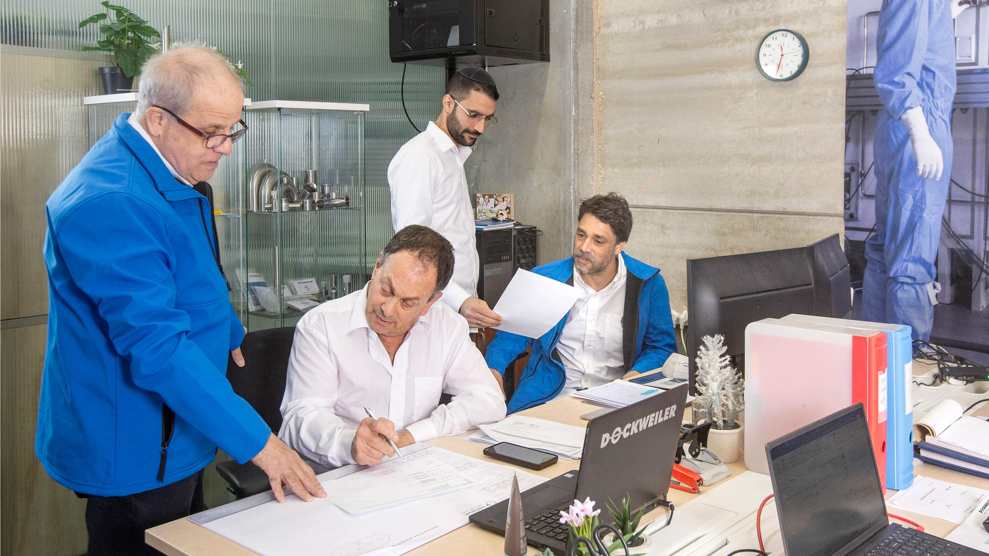 Group of employees having a meeting at their desks in an office environment