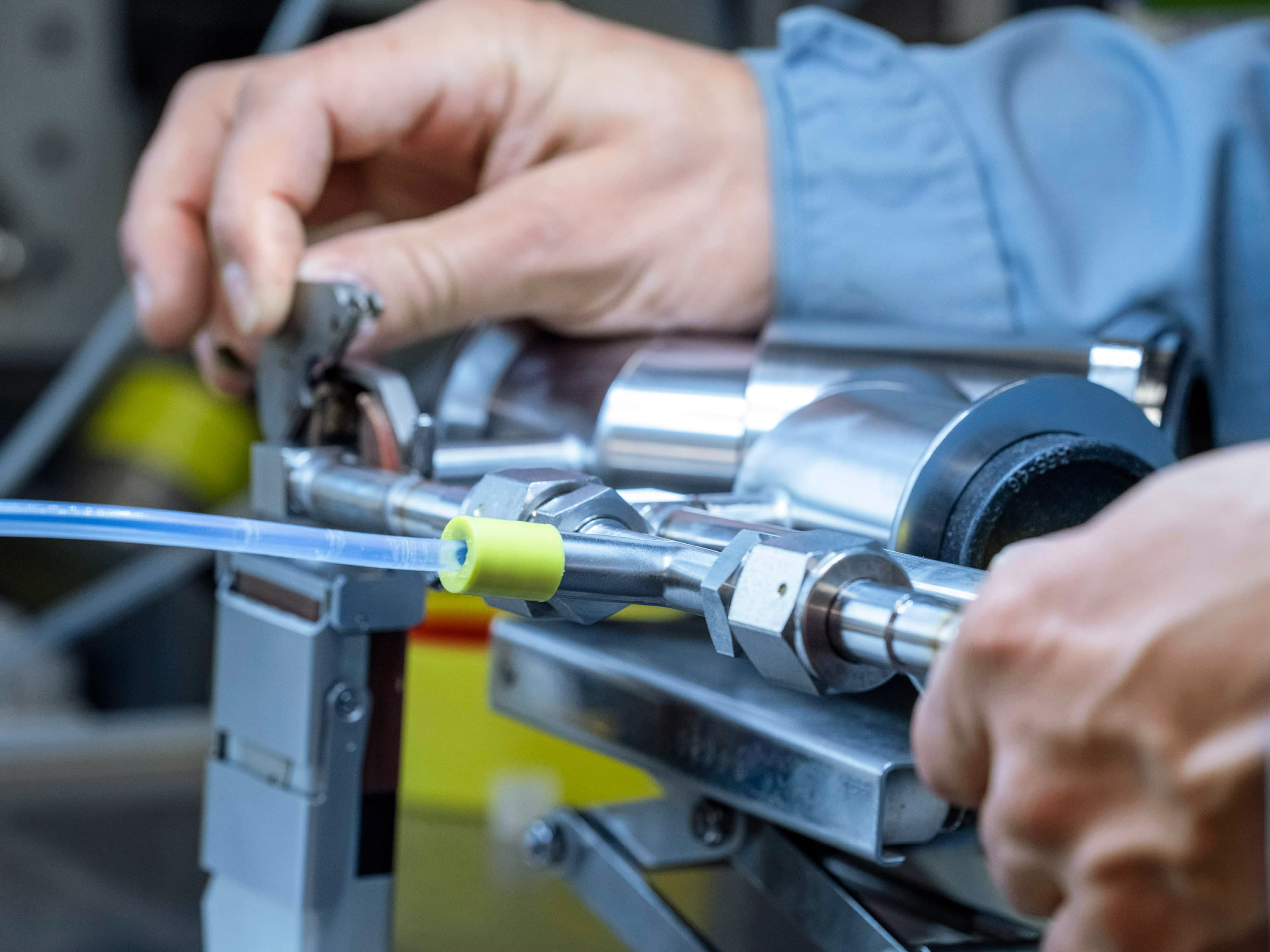 Employee prepares component for welding