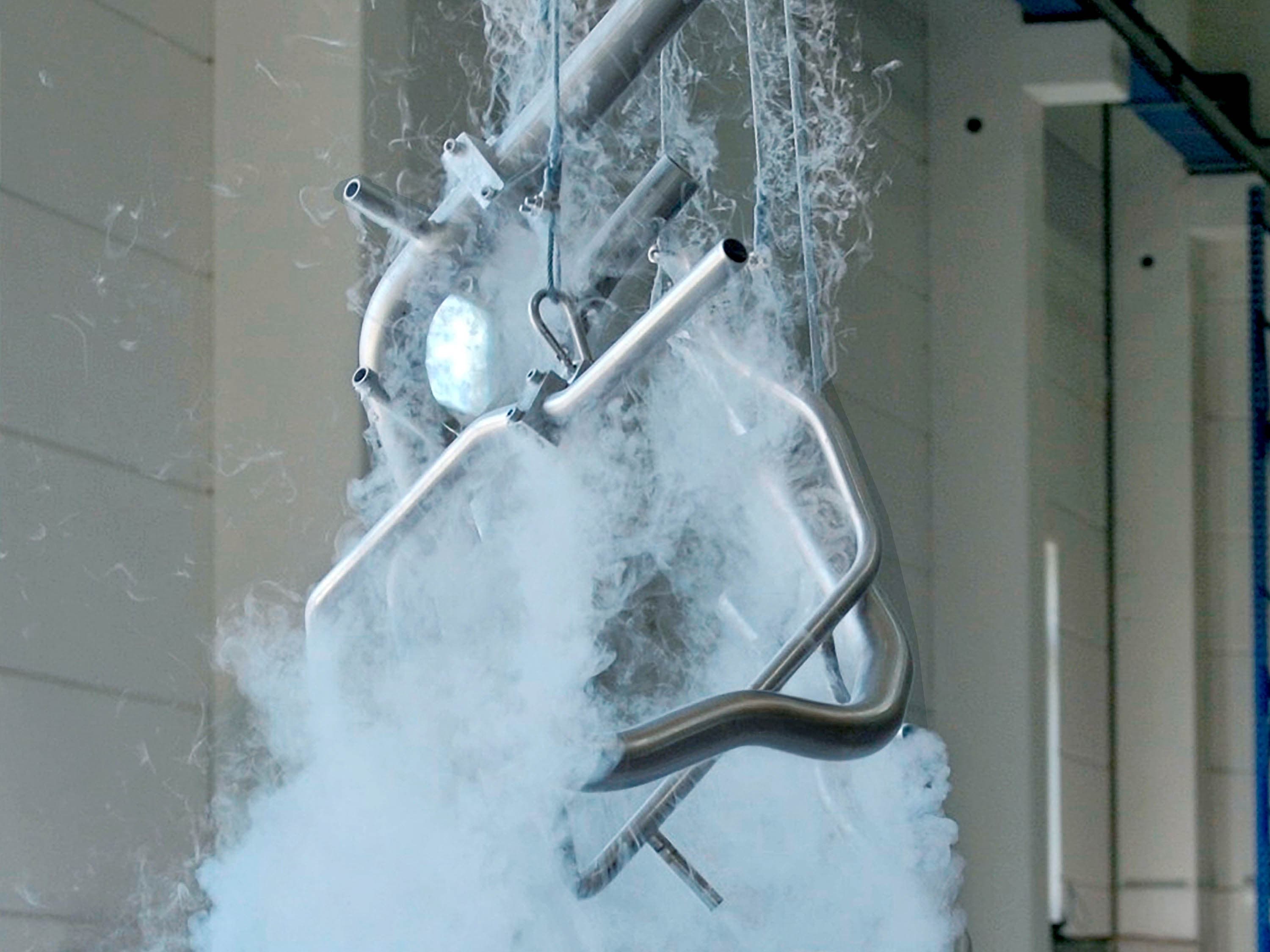 Stainless steel manifold is lifted out of a nitrogen bath